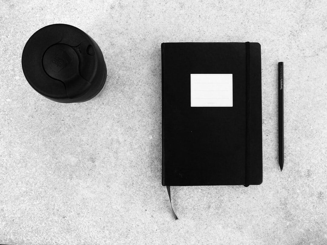 Flat lay of books, a hat and a notebook